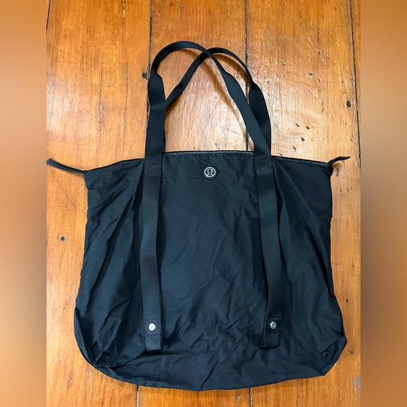 lululemon athletica Handbags - Lululemon black shoulder bag with yoga mat strap wet clothes compartment